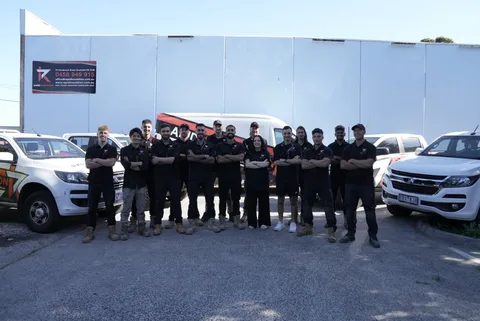 The Rapid Insulation team, in front of their branded vehicles